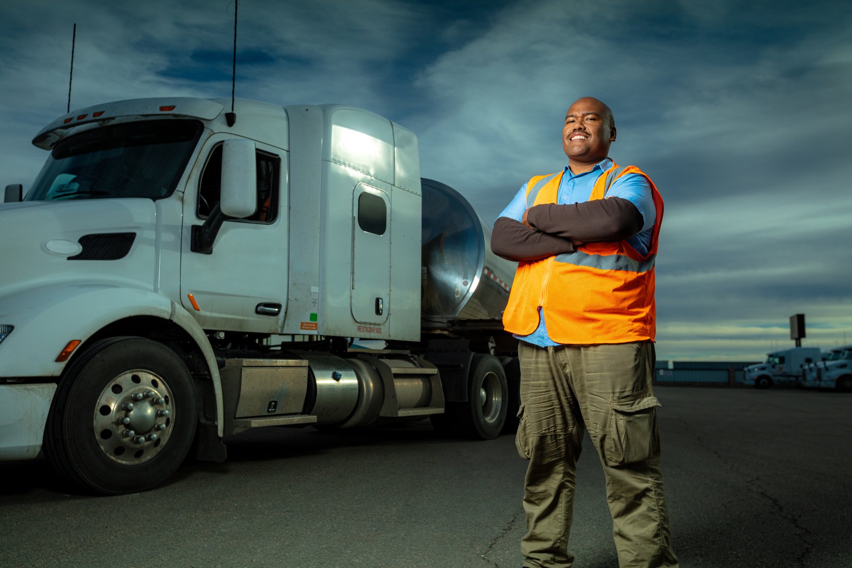 Truck Driver Posing Beside Milk Tanker